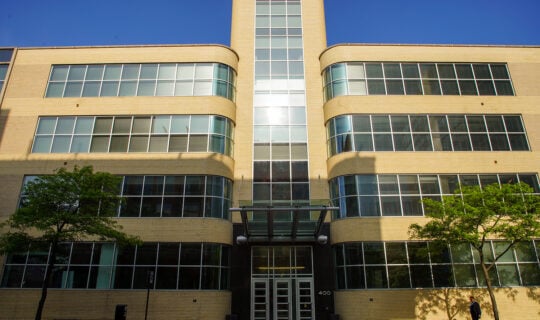 exterior of building with yellowish brick and windows