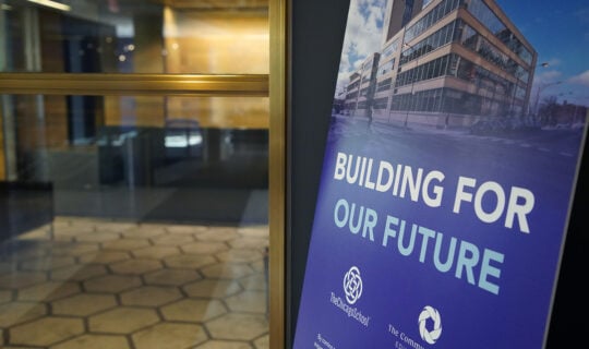 building for our future poster next to door